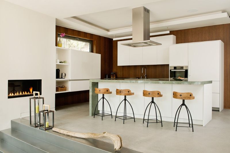 The chef kitchen with marble-topped island and fireplace.