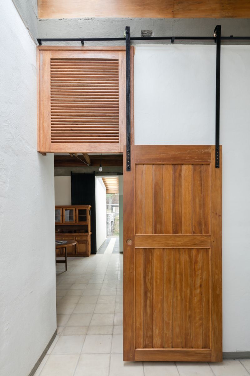 The restored doors were hung from the concrete beams.