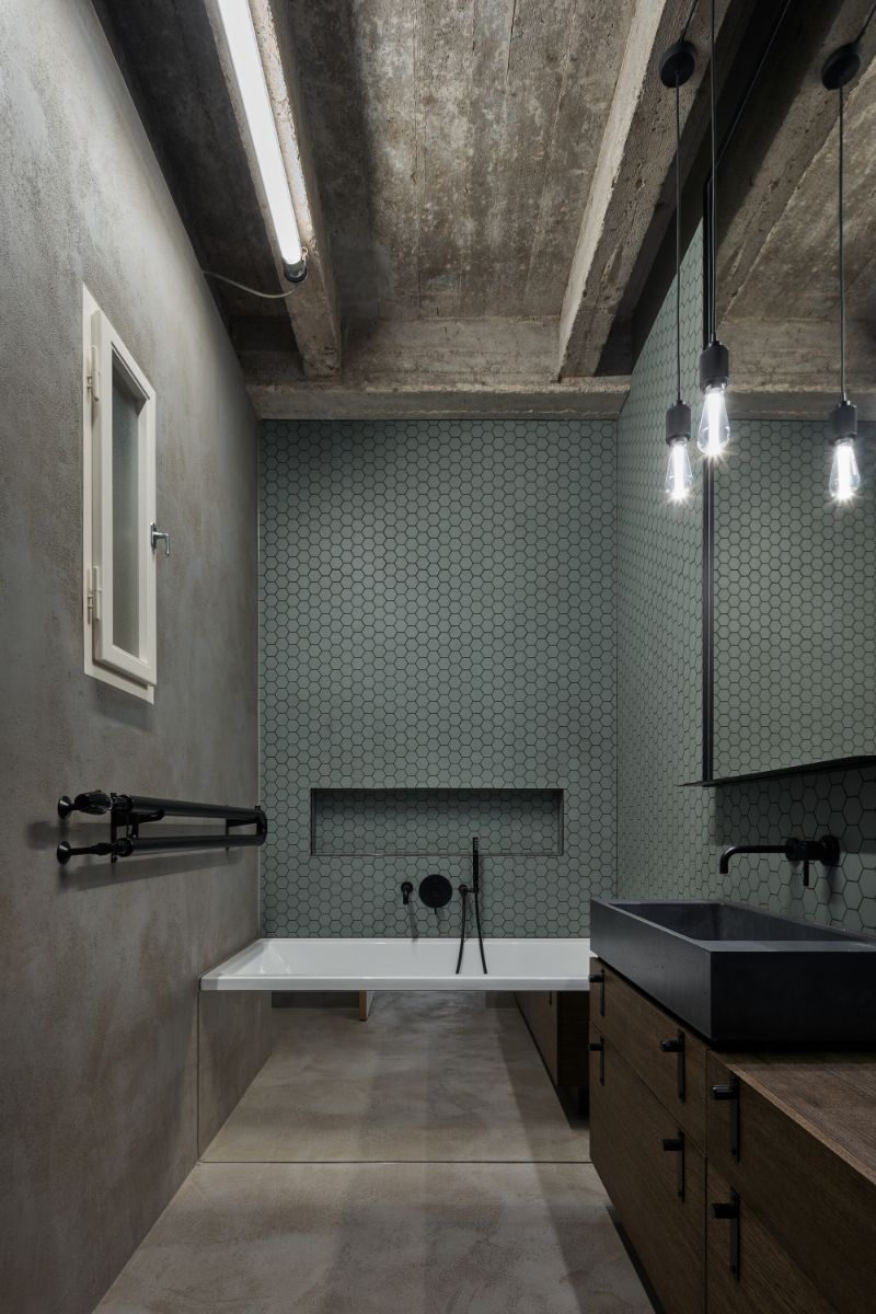 The bathroom with walls that are lined with a matt ceramic mosaic.