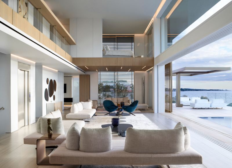 The double-height living space with motorized sliding doors leading to swimmingpool.