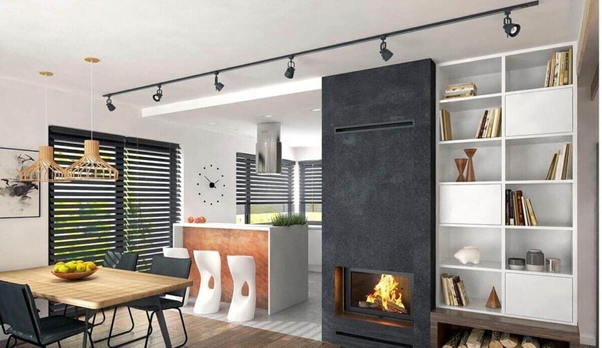 An open layout view of the living area, dining room, and kitchen separated by a bar seating.