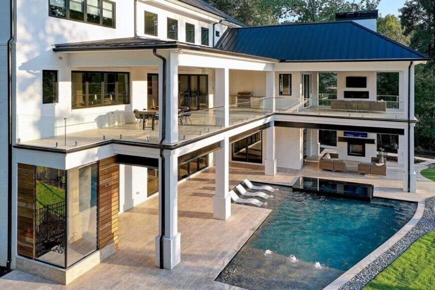 A closer look shows the sparkling pool and fireplaces warming the covered porches.