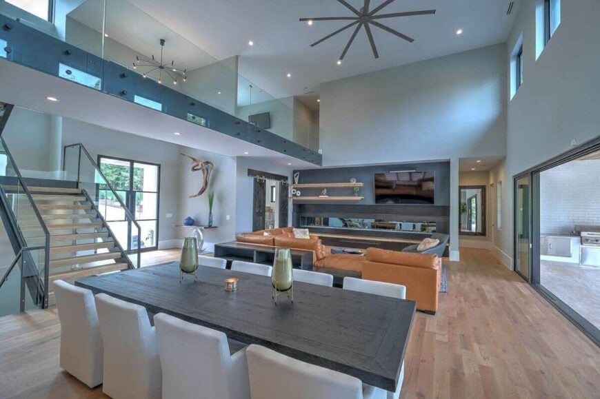 Just behind the living room is the dining area with a dark wood table and gray upholstered chairs.