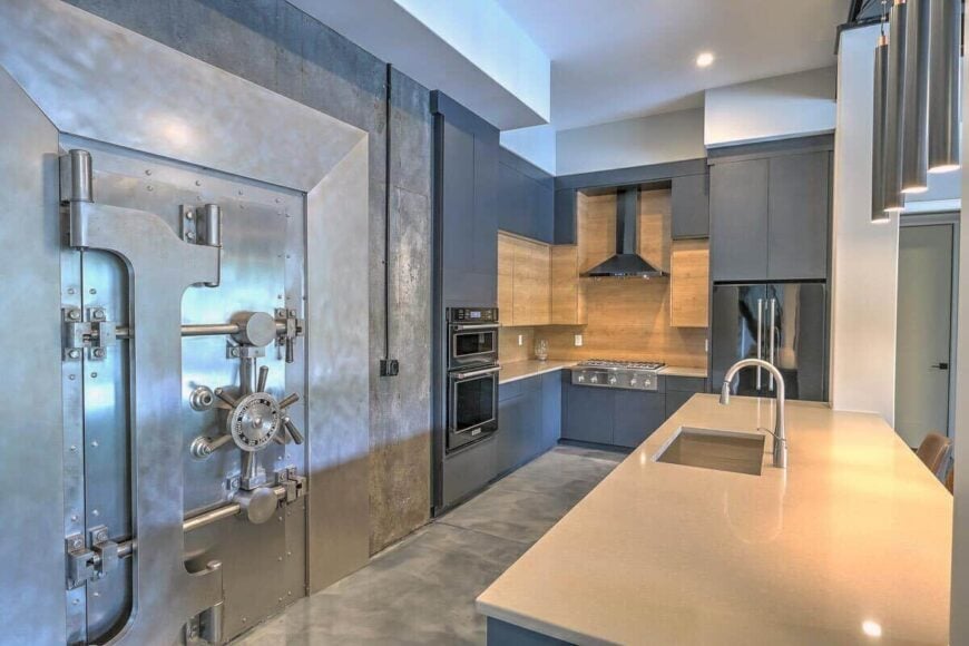 The kitchen includes a walk-in pantry concealed behind the vault door.