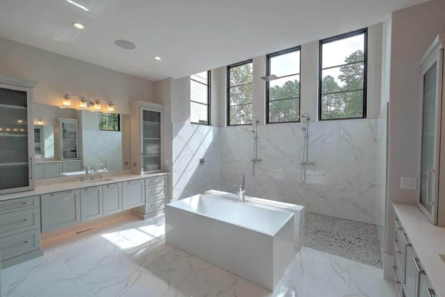 A walk-in shower brightened by large windows completes the primary bathroom.