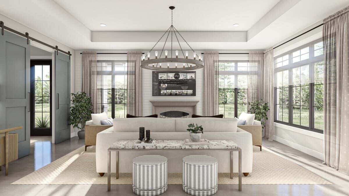 A tray ceiling mounted with an oversized chandelier crowns the living room.