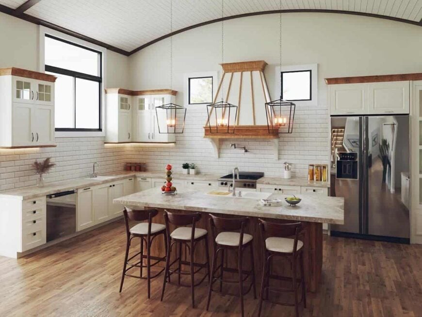 A barrel-vaulted ceiling mounted with caged pendants crowns the kitchen.