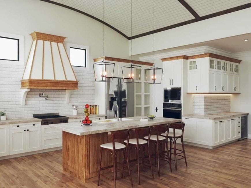 The kitchen includes a white subway tile backsplash, multiple counter spaces, and a breakfast island with four seating.
