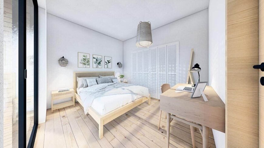 The primary bedroom offers wooden furnishings and a walk-in closet concealed behind the louvered doors.