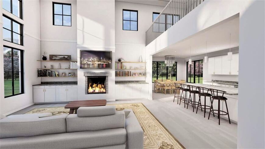 An open layout view of the soaring living room, kitchen, and bright dining area.