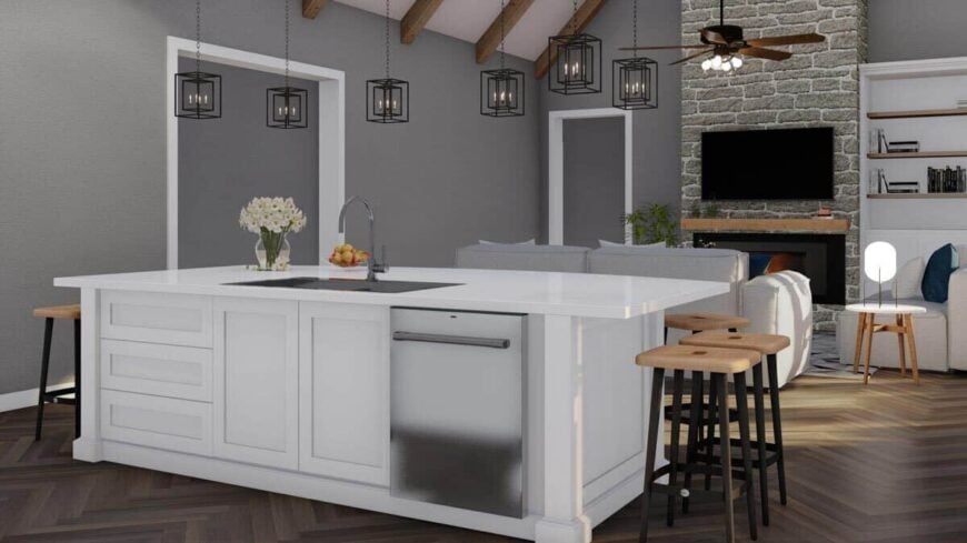 Combined kitchen and living room with gray walls and chevron hardwood floor.