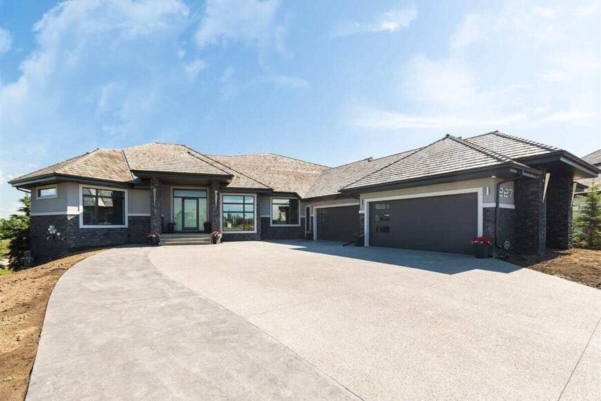 Front exterior view showcasing hipped rooflines, a covered entry porch, and an angled garage complemented with a concrete driveway.