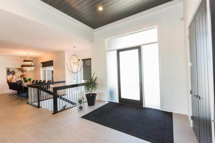 A bright foyer greets you upon entry. It opens into the dining room separated by a basement staircase.