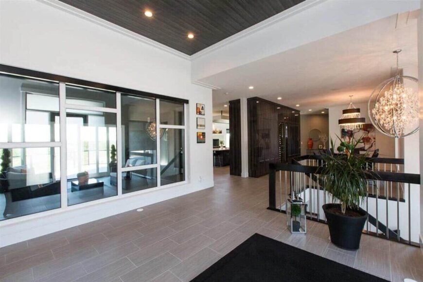 The foyer includes a great view of the rear deck through the large windows.