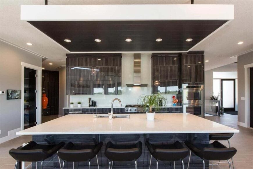 Recessed ceiling lights mounted on the drop ceiling illuminate the kitchen.