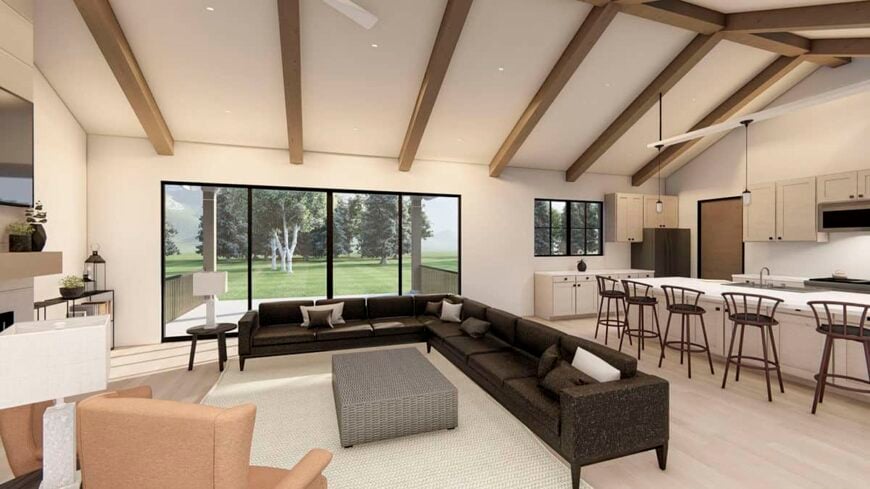 A cathedral ceiling framed with exposed beams crowns the living room and kitchen.