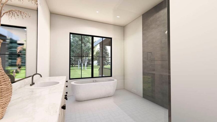 Primary bathroom with a dual sink vanity, a walk-in shower, and a freestanding tub placed under the framed window.