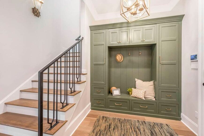 Mudroom with built-in cabinets and bench along with a staircase leading to the upstairs bedrooms.