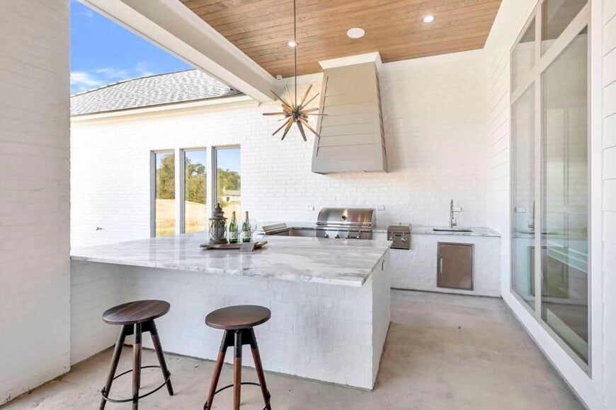 A summer kitchen with bar seating completes the covered porch.