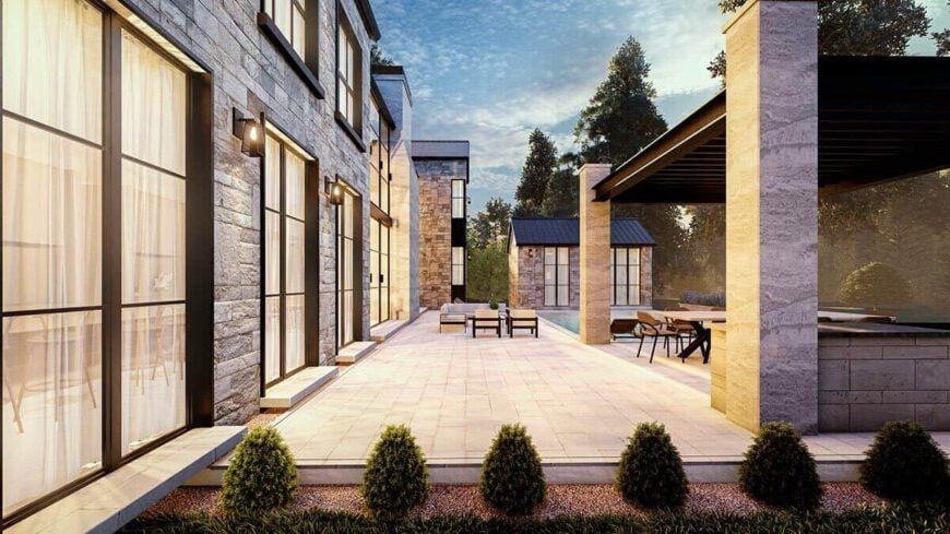 A concrete patio separates the pool terrace from the main home.