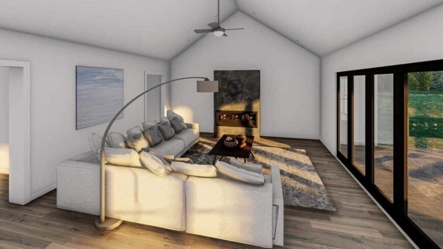 The family room has an L-shaped sectional, an electric fireplace, and a cathedral ceiling.