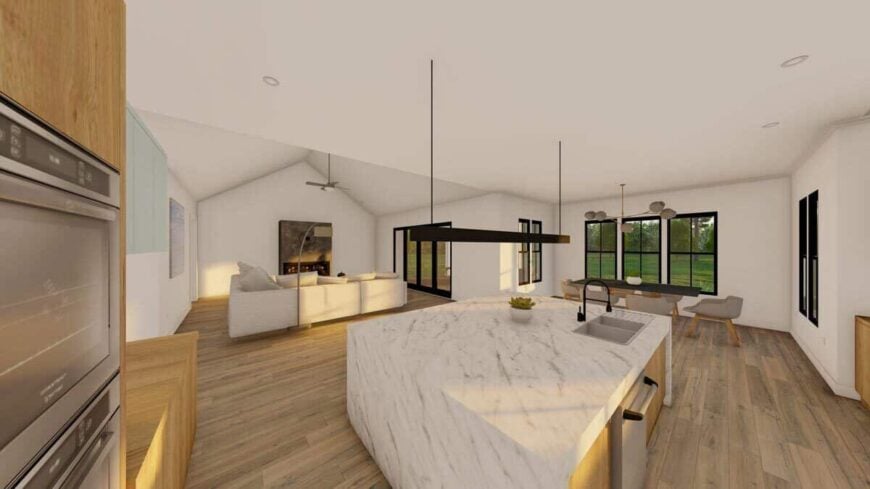 The kitchen features an immense island with double sinks and sweeping views of the living room and dining area.
