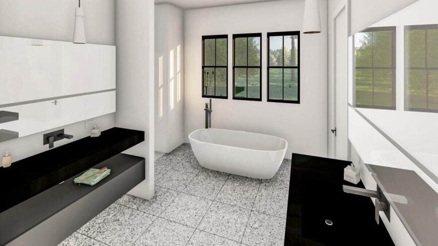 The primary bathroom is equipped with his and her sink vanities, a walk-in shower, and a freestanding tub situated beneath the framed windows.