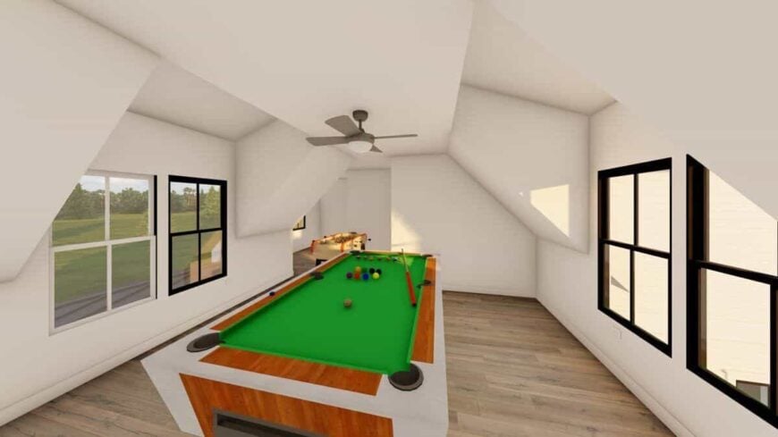 Game area with a vaulted ceiling and a billiards table over the hardwood floor.