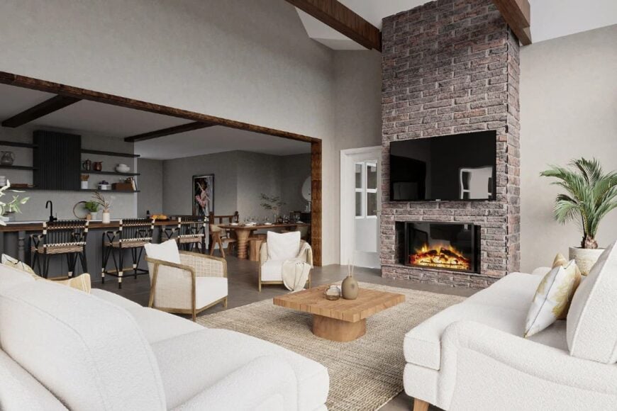A brick fireplace with a large TV on top completes the living room.