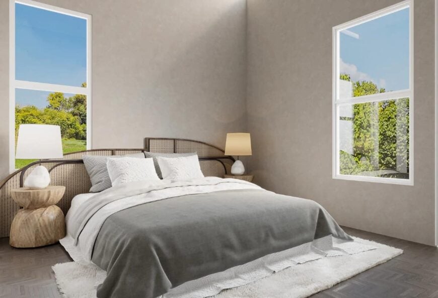 This bedroom features taupe walls and a comfy bed with a bespoke rattan headboard.