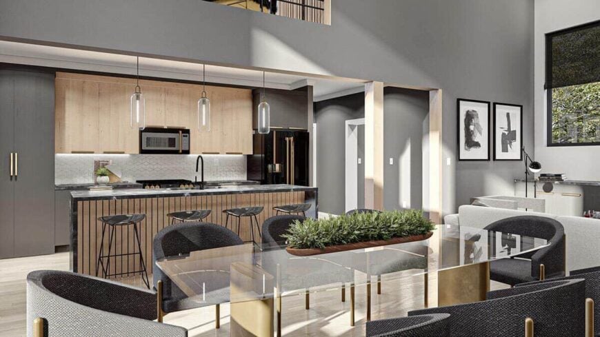 The dining area offers a glass-top table and round-back armchairs. It connects the kitchen and the great room.