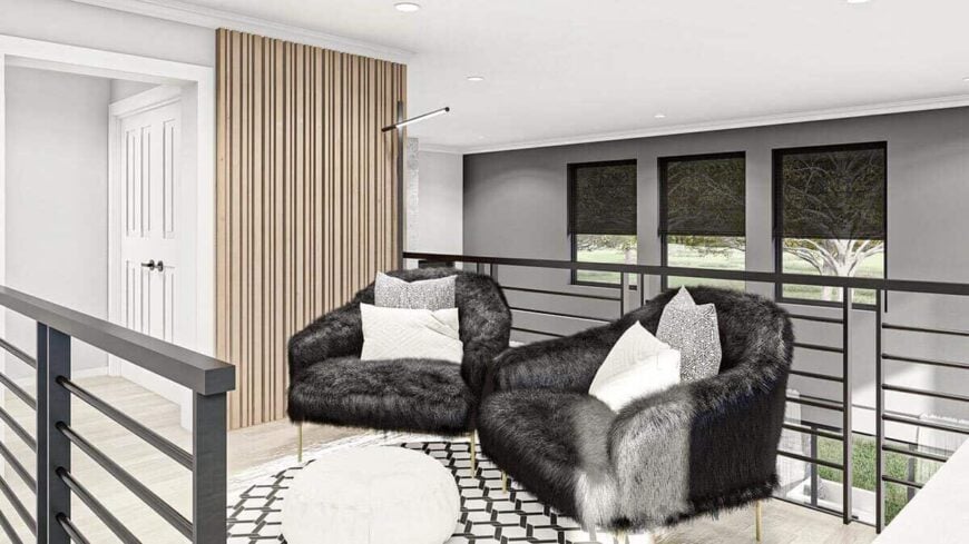 The second level loft has furry armchairs and a view of the combined great room and dining room below.