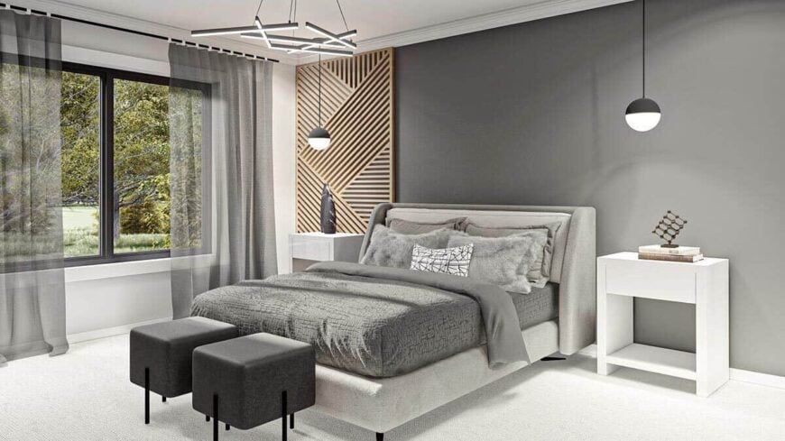 Primary bedroom with carpeted floor, sliding windows, and an upholstered platform bed complemented with gray footstools.