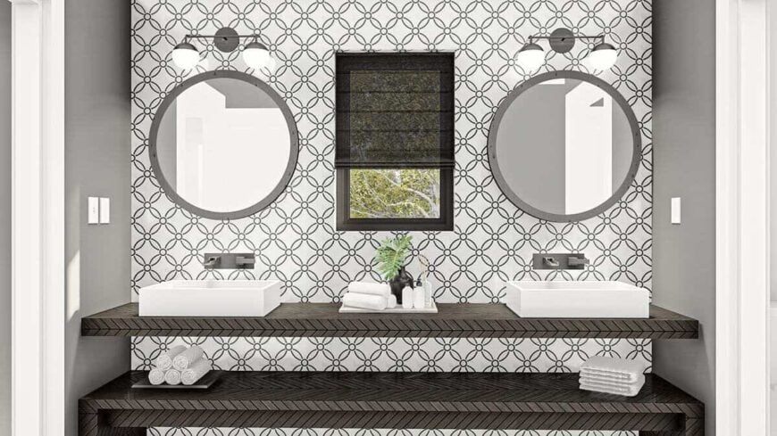 A tiled accent wall creates a nice backdrop to the dual sink vanity of the primary bathroom.