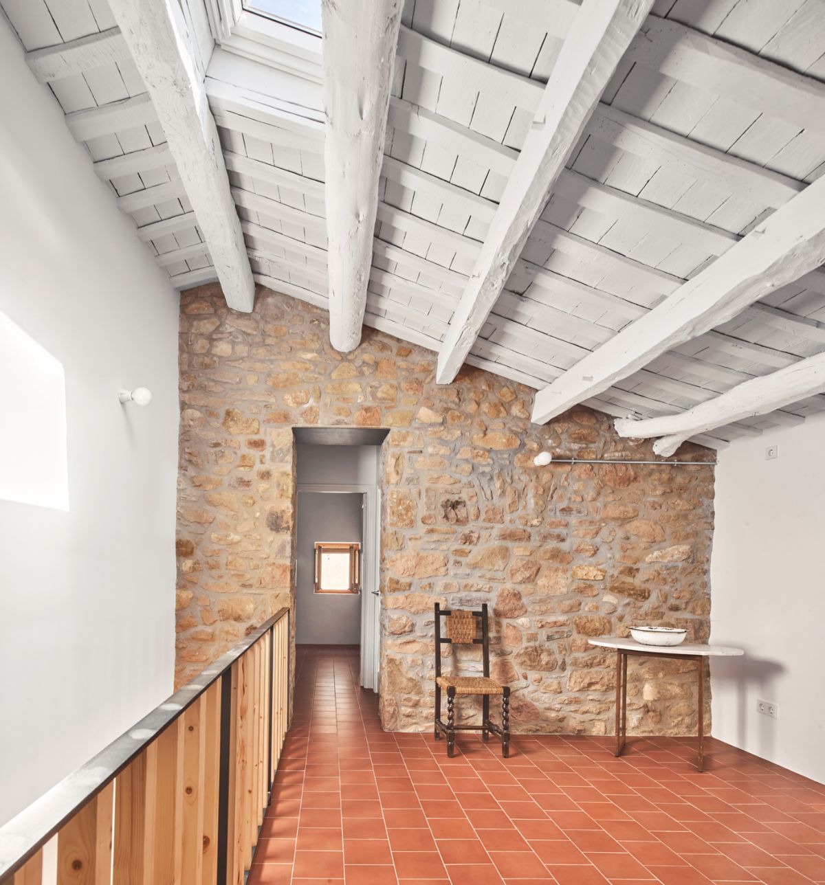 The house has several rooms upstairs and a skylight that helps with the lighting.