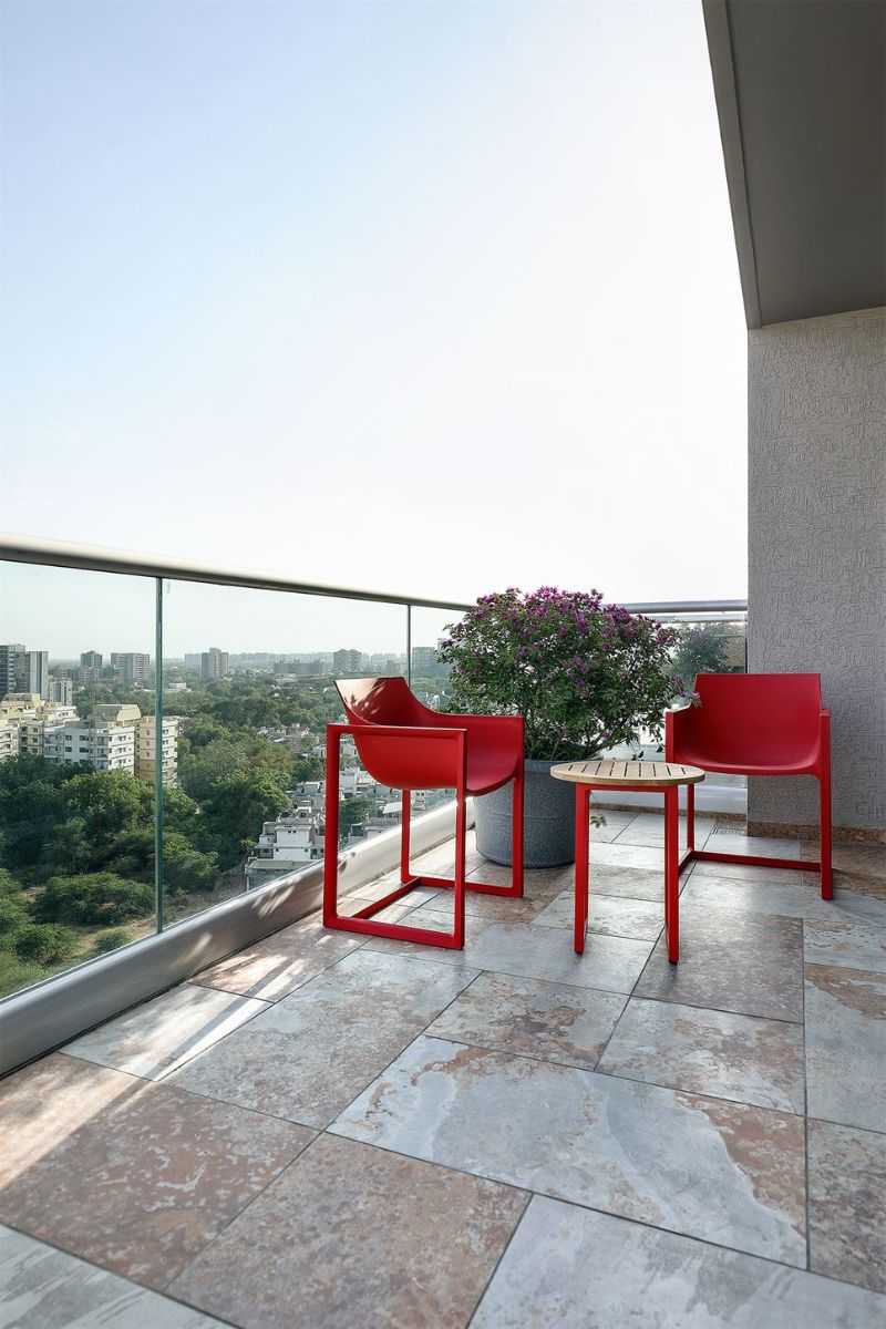 The seating area on the bedroom balcony, with views of the city.