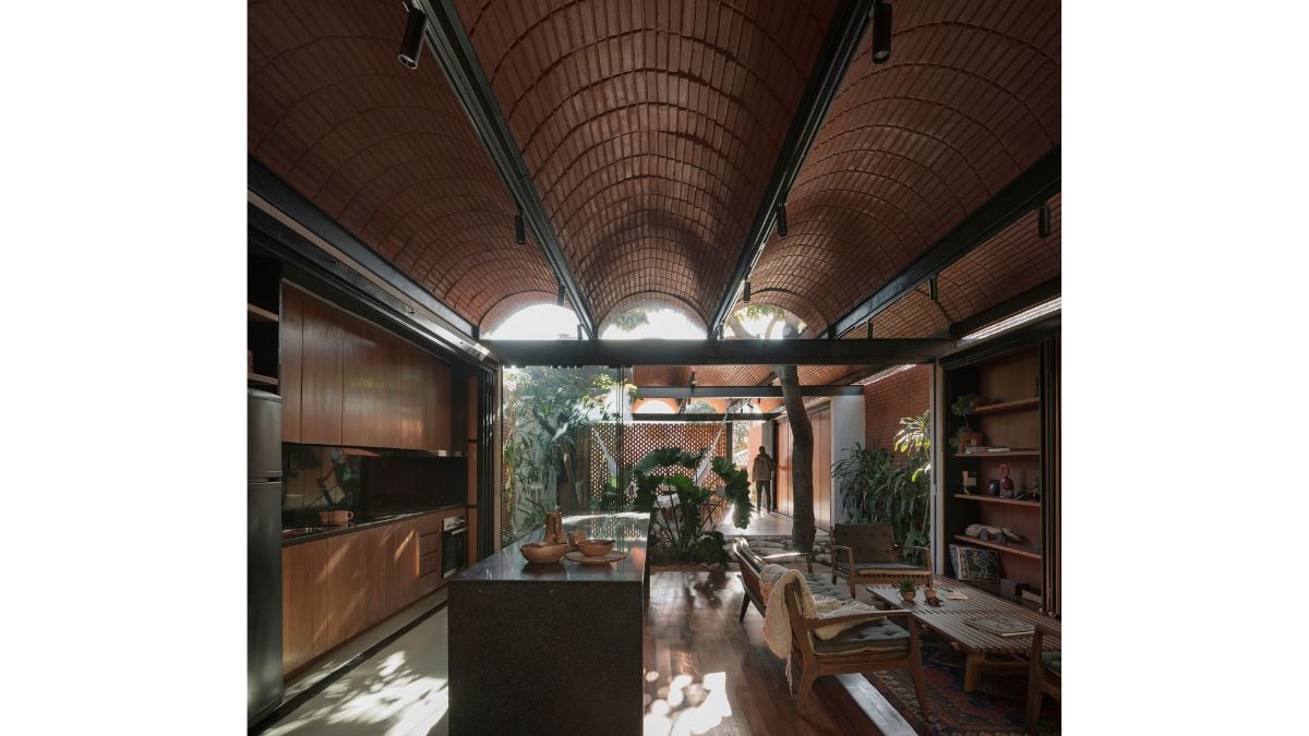 The kitchen and the guest area share the same space, but each area has distinct furnishings that is appropriate for its function.