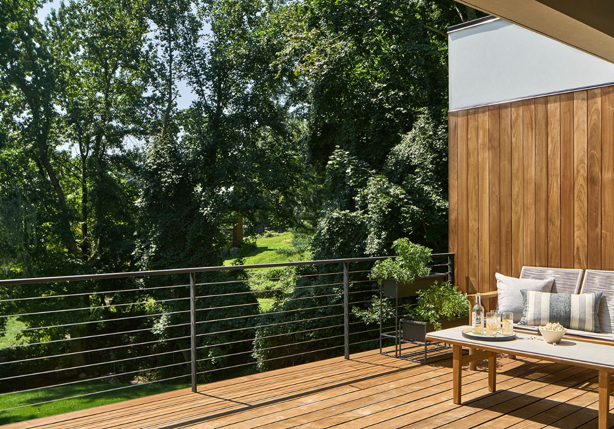 A relaxing living space on the upper deck, surrounded by magnificent trees.