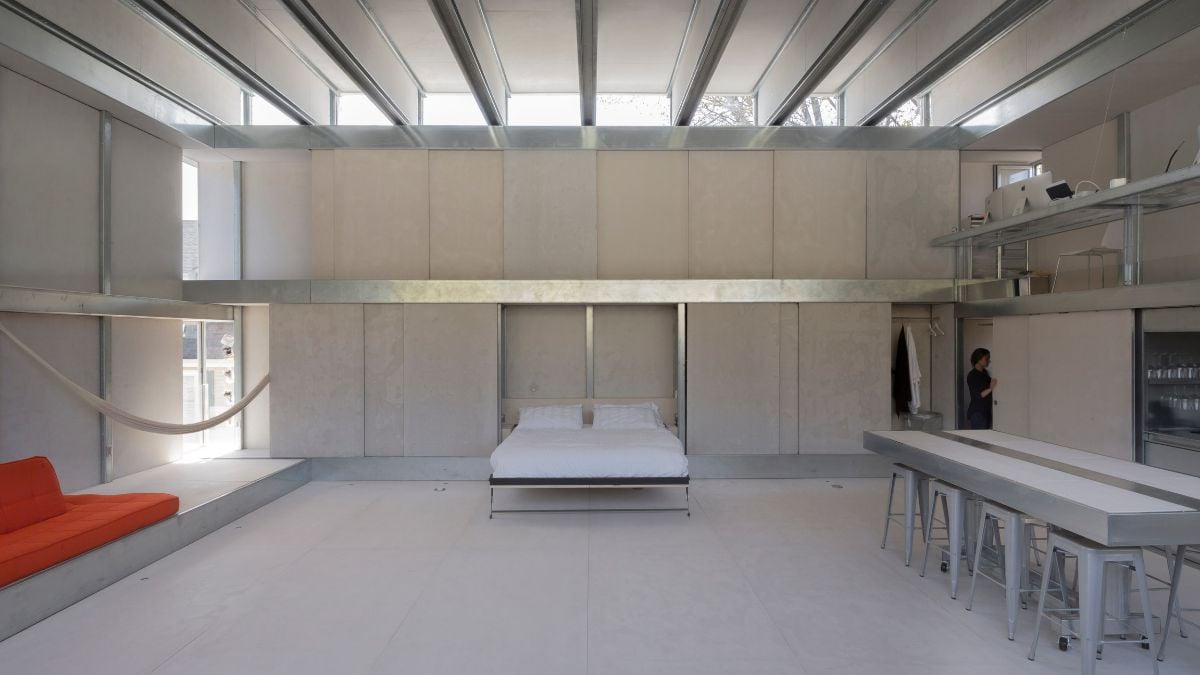 An interior shot showcasing a space-saving design feature, specifically a bed integrated into the wall.