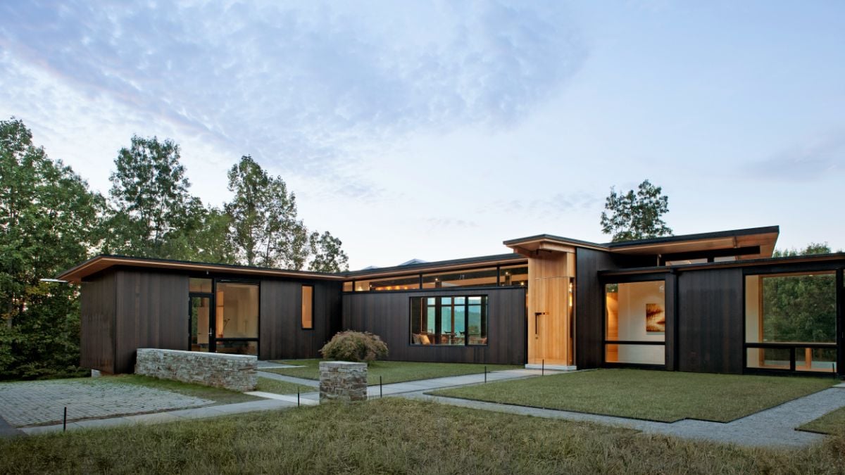Outdoors is a landscape with plants that help cool the surrounding giving the house a cool atmosphere.