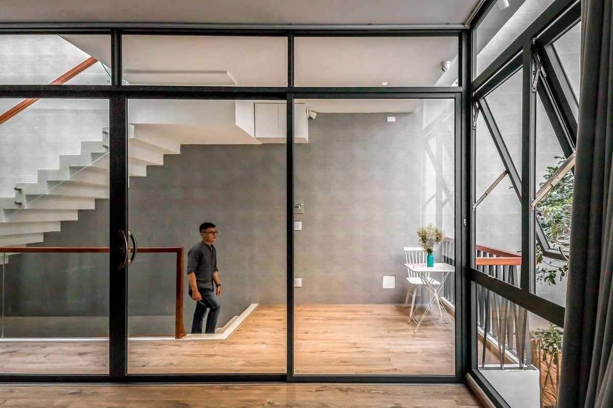 The bedroom is encased in full-height glazing creating a sense of space and connection.