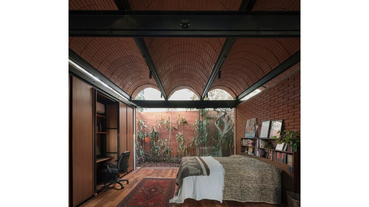 The bedroom is spacious and fashioned of brick stones and wood components from the floor to the ceiling.