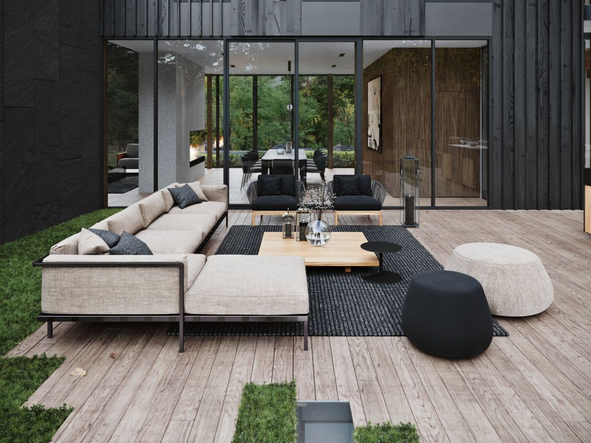 The patio with a wooden deck blends well with the sofa creating a cozy atmosphere.