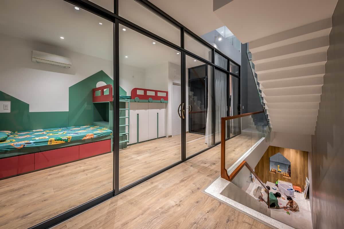 A narrow hallway leads to another bedroom.