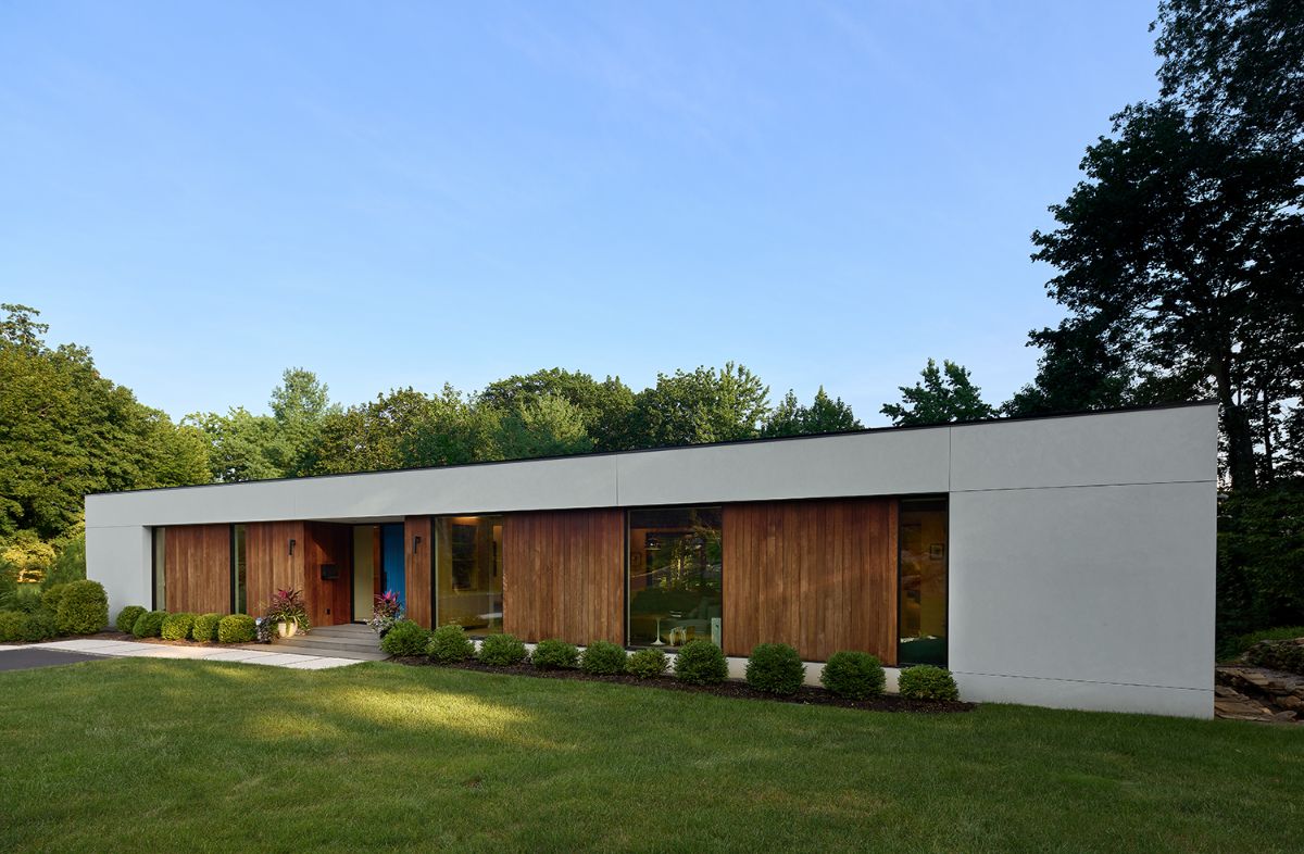 A rectangle house design with well-kept landscaping.