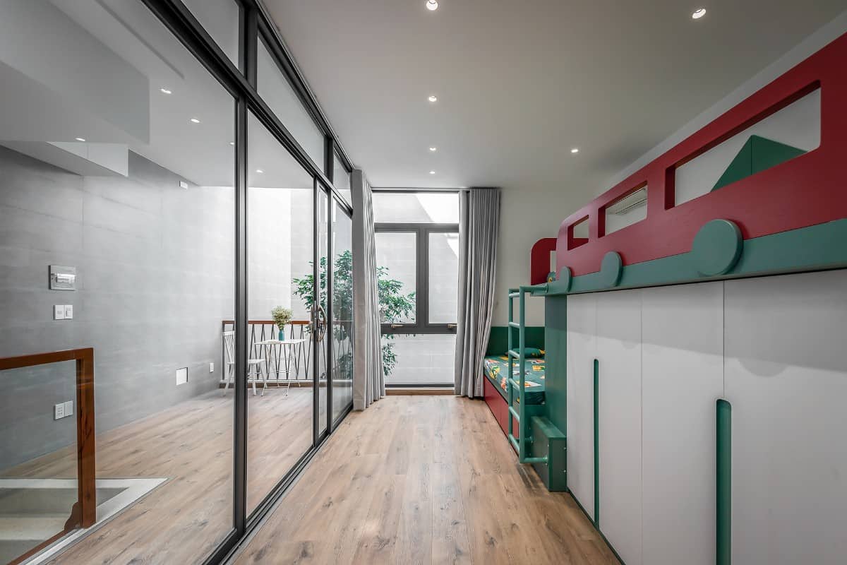 The kids' bedroom features a custom bunkbed incorporated with a closet.