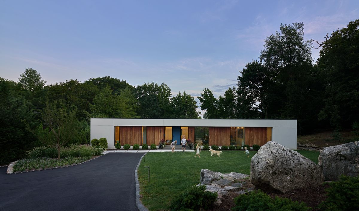 A formalized rectangle house that is low to the ground.