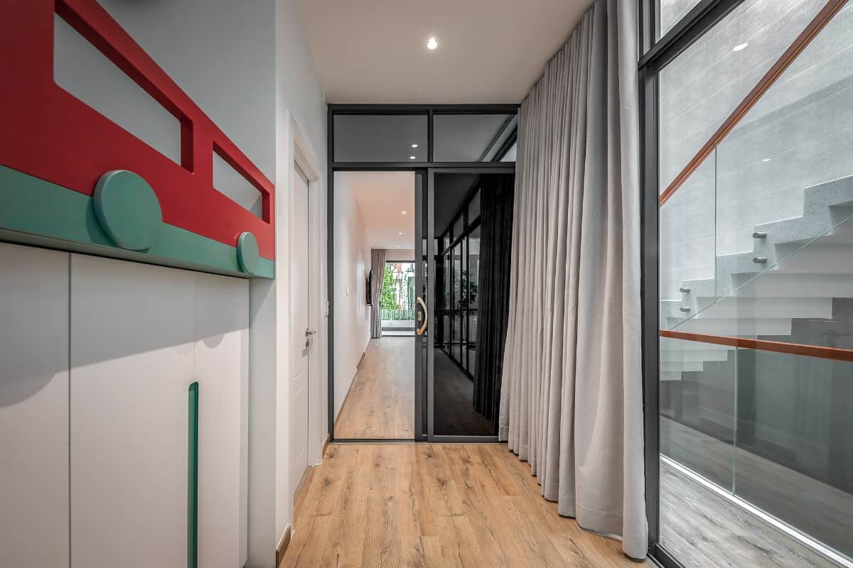 A sliding glass door connects the kids' bedroom to the primary suite.