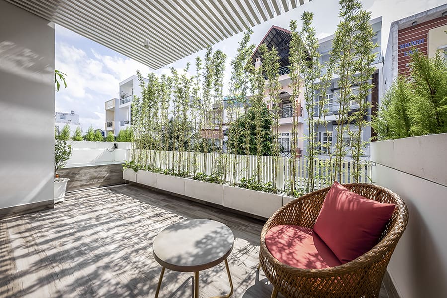 The porch is lined with tall and lush plants offering optimum relaxation.