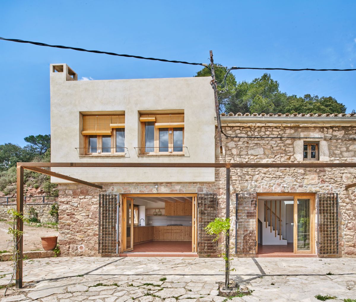 The exterior of the house is made up with stone walls and pergola.